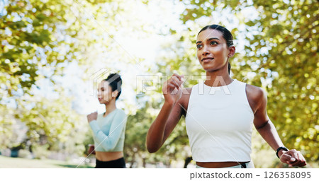 Women, fitness and workout in park with teamwork, exercise or support for endurance. Athlete, runner friends and running with marathon, training or development in nature for wellness and health goal 126358095