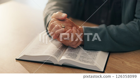 Hands, bible study and religion in home, retirement and reading scripture for marriage, info and spiritual knowledge. Elderly person, book and faith with story, chapter or gospel for God at apartment 126358099