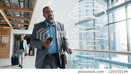 Businessman, walking and phone with suitcase for travel, job opportunity or career trip at airport. Man, employee or traveler with mobile smartphone or luggage for business commute or flight app Businessman, walking and phone with suitcase for travel, job opportunity or career trip at airport. Man, employee or traveler with mobile smartphone or luggage for business commute or flight app 126358194