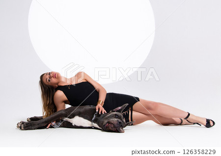 Portrait of beautiful sexy model in the black dress with german dogge on a white background Portrait of beautiful sexy model in the black dress with german dogge on a white background 126358229