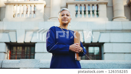 Lawyer, folder and portrait with business woman in city for court case files, trial assessment and attorney brief. Plead agreement, low angle and advocate paperwork with mature person outdoor Lawyer, folder and portrait with business woman in city for court case files, trial assessment and attorney brief. Plead agreement, low angle and advocate paperwork with mature person outdoor 126358285