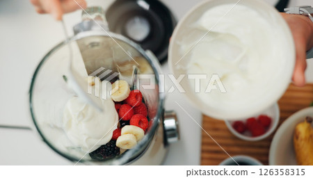 Fruit smoothie, hands and yogurt in blender for breakfast shake, meal replacement and healthy nutrition. Above, machine and preparation in kitchen for weight loss beverage, person diet and wellness Fruit smoothie, hands and yogurt in blender for breakfast shake, meal replacement and healthy nutrition. Above, machine and preparation in kitchen for weight loss beverage, person diet and wellness 126358315