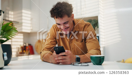 Home, smile and man on smartphone in kitchen for communication, morning news and message. Reading, online and happy person on mobile for texting, social media and website to download application Home, smile and man on smartphone in kitchen for communication, morning news and message. Reading, online and happy person on mobile for texting, social media and website to download application 126358363