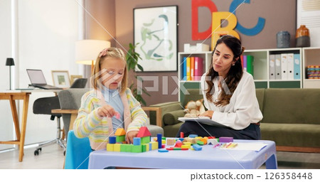 Exam, kid and building blocks with woman in psychology for consulting, child development or play therapy. Education therapist, advice and mental health evaluation with person and girl with toys 126358448