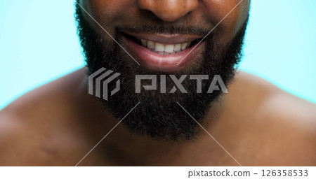 Beard, grooming and mouth of black man on blue background for morning maintenance routine. Beauty, facial hair and self care with person closeup in studio for personal hygiene, relax or wellness 126358533