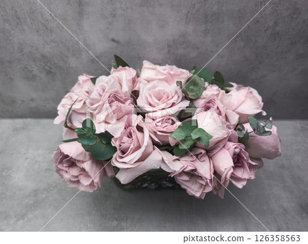 Delicate pink roses forming a bridal bouquet on a gray background wallpaper copy space 126358563
