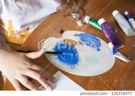 Close-up of a child hands smearing bright paints. Kids artistic creativity. 126358977
