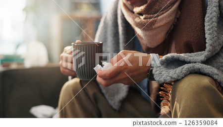 Hands, tissue and person with tea in living room, sick or health issue with influenza, hayfever or sinusitis. Hot beverage, electrolyte liquid or medicine for illness, wellness and flu at house Hands, tissue and person with tea in living room, sick or health issue with influenza, hayfever or sinusitis. Hot beverage, electrolyte liquid or medicine for illness, wellness and flu at house 126359084