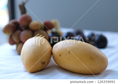 Top view of colorful fresh tropical fruits, in basket for sale at Vietnam local street, including mango, lychee, longan and mangosteen 126359091