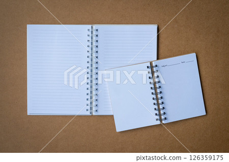 Two open journal notebooks on top of desk. Two open journal notebooks on top of desk. 126359175