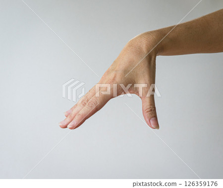 Woman hand form a gesture of picking up something. Woman hand form a gesture of picking up something. 126359176