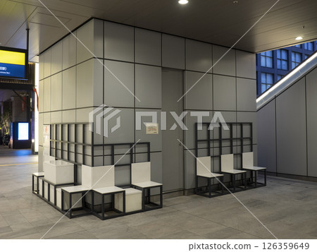 Public bench in the plaza in front of the Shinjuku New South Exit ticket gates. 126359649