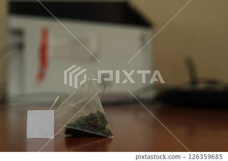Green tea bag on a table. Green tea bag on a table. 126359685