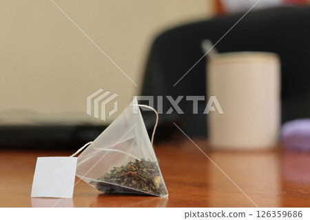 Green tea bag on a table. Green tea bag on a table. 126359686