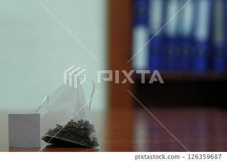 Green tea bag on a table. Green tea bag on a table. 126359687