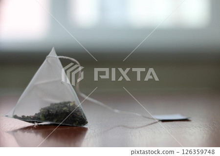 Green tea bag on a table. 126359748