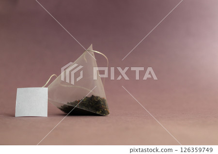Green tea bag on a table. Green tea bag on a table. 126359749