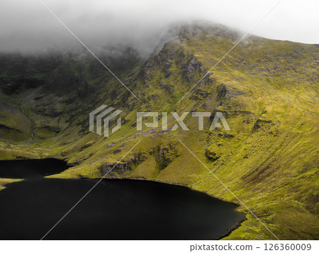 Majestic view of Coomloughra Lough in Coomloughra, Ireland during misty weather. 126360009