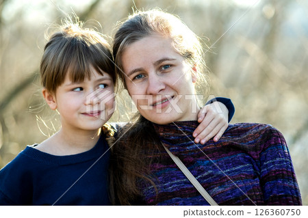 Young mom and her daughter girl together outdoors. Young mom and her daughter girl together outdoors. 126360750