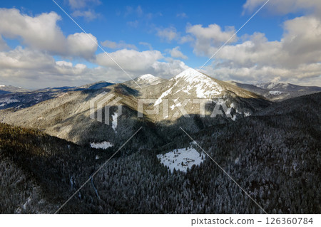 Winter landscape with spruse trees of snow covered forest in cold mountains. Winter landscape with spruse trees of snow covered forest in cold mountains. 126360784