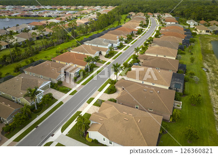 View from above of densely built residential houses in closed living clubs in south Florida. American dream homes as example of real estate development in US suburbs 126360821