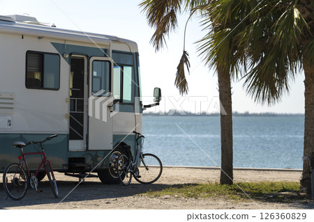USA travel by motorhome. Camping vehicle parked on ocean shore in sunny Florida. Travel infrastructure. 126360829