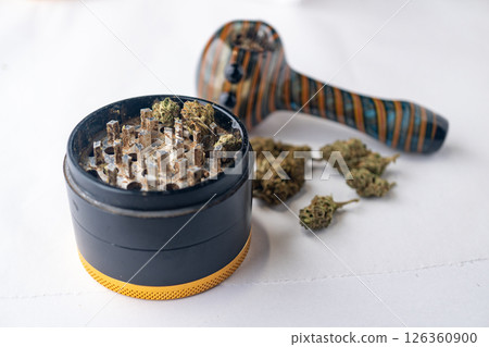 Marijuana Cannabis weed buds with pipe and grinder. Marijuana Cannabis weed buds with pipe and grinder. 126360900