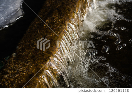 A frozen waterfall. Ice on the river 126361128