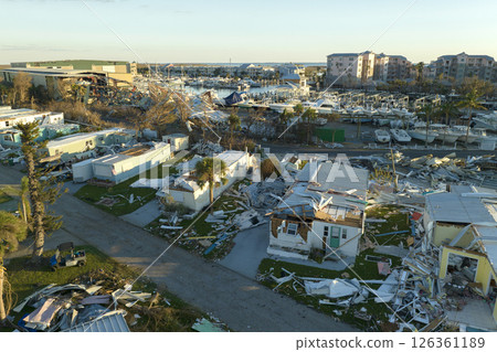 Strong hurricane winds severely damaged private houses in Florida mobile home residential area. Consequences of natural disaster 126361189