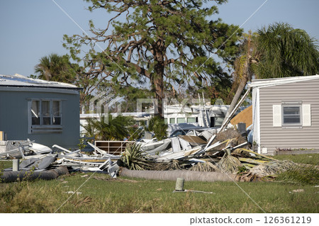 Severely damaged houses after hurricane Ian in Florida mobile home residential area. Consequences of natural disaster Severely damaged houses after hurricane Ian in Florida mobile home residential area. Consequences of natural disaster 126361219