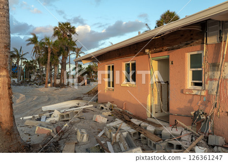 Ruined buildings in need of demolition or repair. Storm surge water and wind damaged houses roof and collapsed walls after hurricane in Florida 126361247