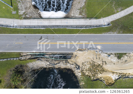 Road construction. Repair of destroyed bridge after hurricane flooding water washed away asphalt in Florida. Construction roadwork site 126361265
