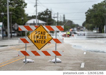 Road closed because of flooding danger with warning signs blocking driving of cars Road closed because of flooding danger with warning signs blocking driving of cars 126361266
