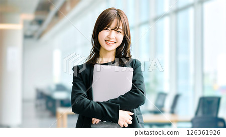Smiling woman/businesswoman with a laptop Smiling woman/businesswoman with a laptop 126361926