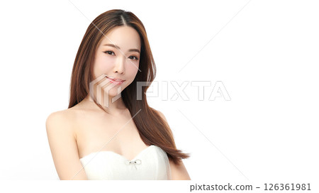 A beautiful young Asian woman with clean, fresh skin against a white background. Skincare, facial treatment, cosmetology, beauty, and spa. An elegant portrait of an Asian woman. 126361981
