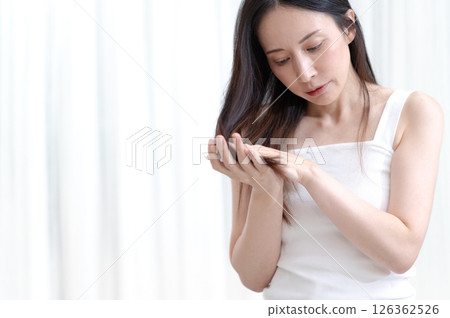 A woman touching her hair A woman touching her hair 126362526