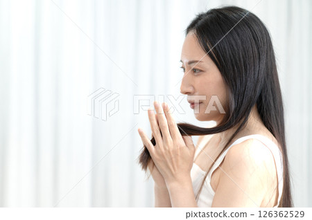 A woman touching her hair A woman touching her hair 126362529