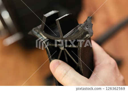 Man holding broken leg of office chair: workplace trouble, defective chair Man holding broken leg of office chair: workplace trouble, defective chair 126362569