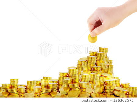 Image of a gold coin in hand and a pile of gold coins. 126362575