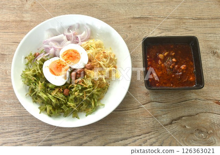 spicy and sour slice wing bean and banana blossom with chop pork sauce topping boiled egg Thai salad on plate spicy and sour slice wing bean and banana blossom with chop pork sauce topping boiled egg Thai salad on plate 126363021