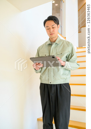Japanese man in work clothes inspecting home facilities 126363465