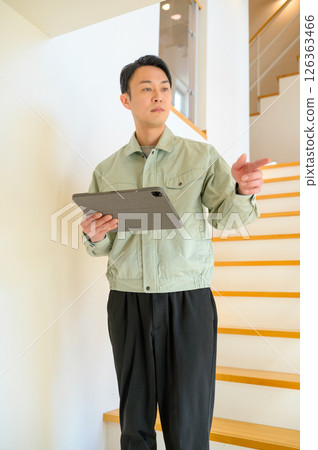 Japanese man in work clothes inspecting home facilities 126363466