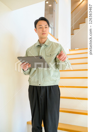 Japanese man in work clothes inspecting home facilities 126363467