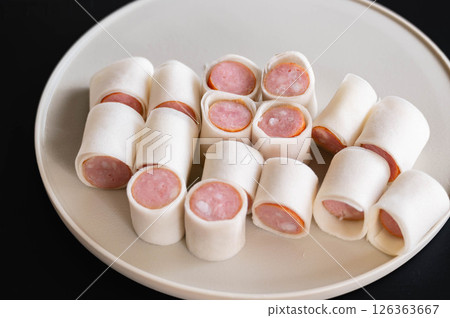 Sausage wrapped in cut spring roll wrappers Sausage wrapped in cut spring roll wrappers 126363667