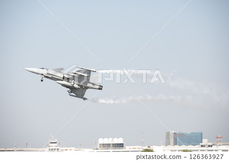 Fighter plane on blue sky background behind technology Fighter plane on blue sky background behind technology 126363927