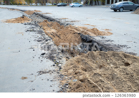 backfilling a trench with earth. construction work to replace a city water pipe 126363980