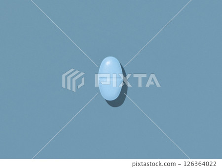Oval blue Medical pill on blue top view, hard shadows. Preventive medicine and healthcare Oval blue Medical pill on blue top view, hard shadows. Preventive medicine and healthcare 126364022