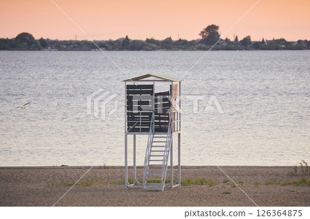 Observation tower for monitoring the beach on the shore in the evening Observation tower for monitoring the beach on the shore in the evening 126364875