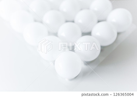 round white LED light bulb. many modern light bulbs on a white table round white LED light bulb. many modern light bulbs on a white table 126365004