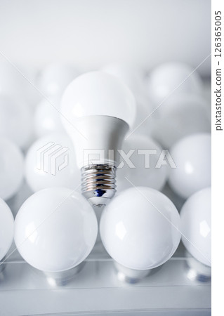 round white LED light bulb. many modern light bulbs on a white table 126365005